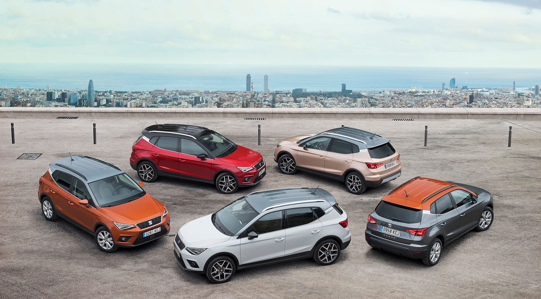 Cinq SUV SEAT Arona garés avec vue sur Barcelone