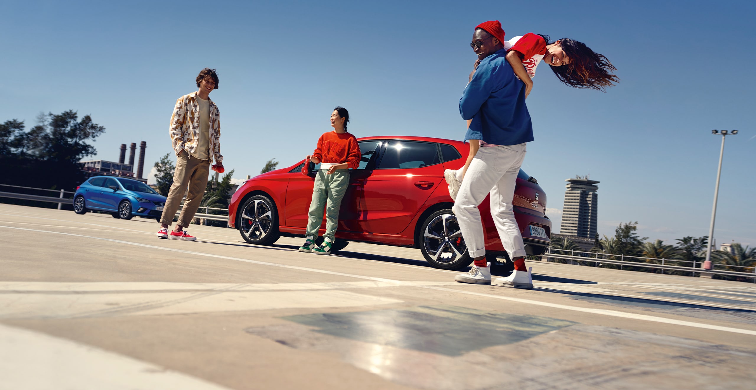 friends sitting on the beach next to a SEAT Ibiza 