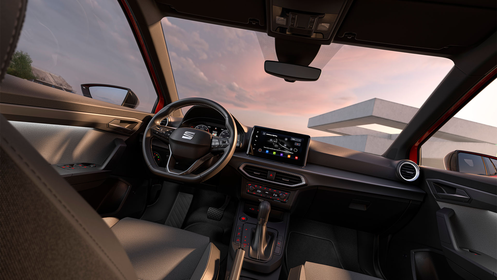 Vue de l’habitacle de la SEAT Arona mettant en valeur certains détails de design, tels que le volant, le tableau de bord et une partie de la sellerie.